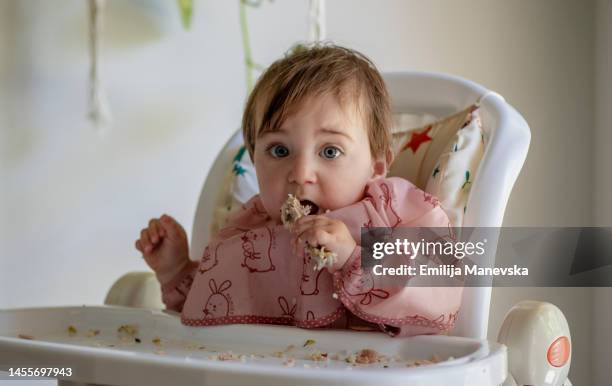 cute baby girl eating meat - baby chicken bildbanksfoton och bilder