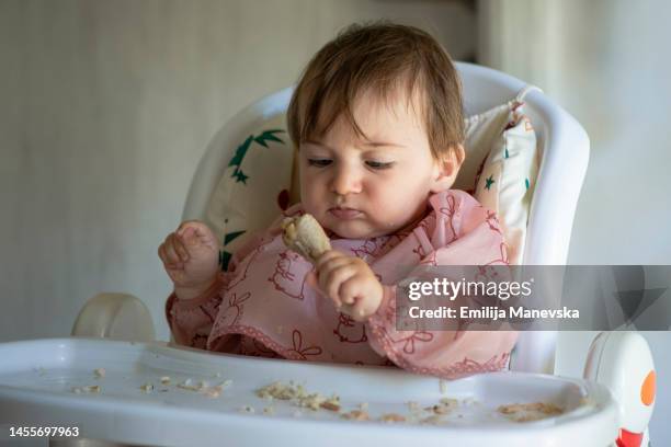 cute baby girl eating meat - baby chicken bildbanksfoton och bilder