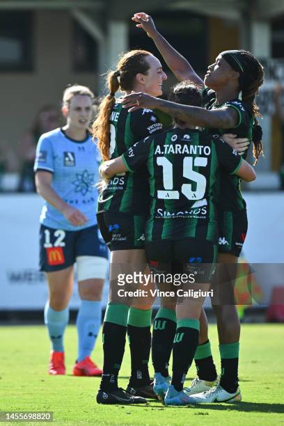 United players Adriana Taranto and Jessica McDonald celebrate after Hannah Keane of Western United scored her second goal during the round 16...