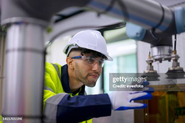 technician work with robotic arm. - young adult working stock pictures, royalty-free photos & images