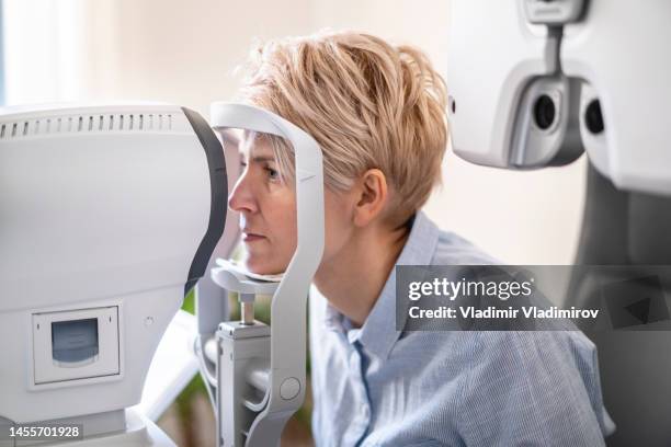 woman siting and ready for an eye test - doctor's office stock pictures, royalty-free photos & images