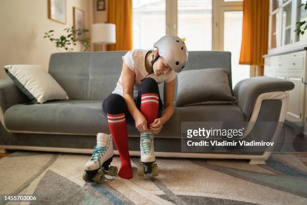 a woman carefully lacing up her roller boots - lace fastener stock pictures, royalty-free photos & images