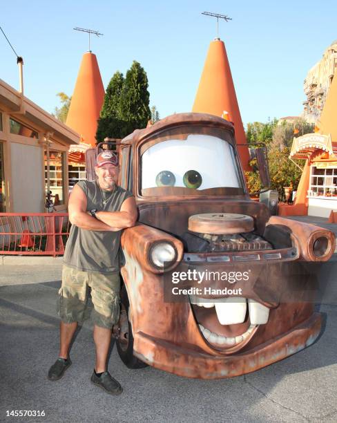 In this handout photo provided by Disney Parks, Larry the Cable Guy meets his animated alter-ego Mater while getting a preview of the new Cars Land...