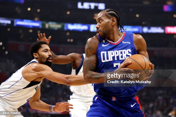 Kawhi Leonard of the Los Angeles Clippers handles the ball against Spencer Dinwiddie of the Dallas Mavericks during the first quarter at Crypto.com...