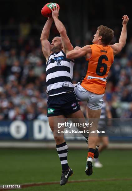 Paul Chapman of the Cats marks in front of Luke Power of the Giants during the round 10 AFL match between the Geelong Cats and the Greater Western...