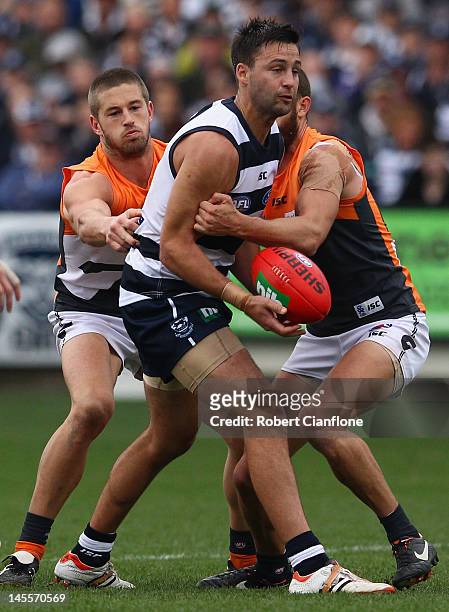 Jimmy Bartel of the Cats looks to handball during the round 10 AFL match between the Geelong Cats and the Greater Western Sydney Giants at Simonds...
