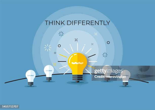 bright light bulb symbol representing a new invention. think differently, standing out from the crowd - think differently concept stock illustrations