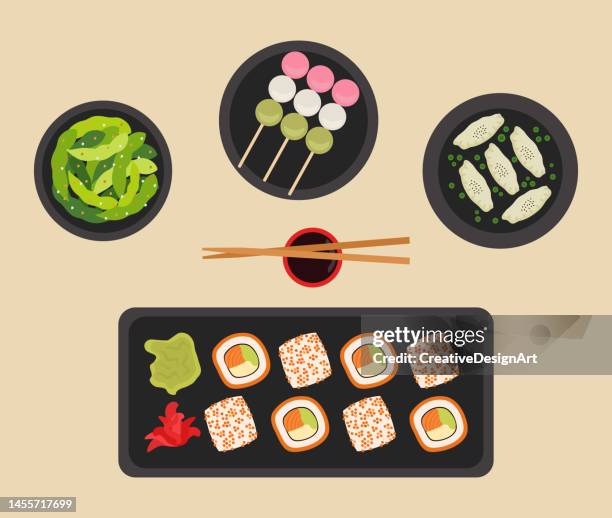 japanisches essen plates.top blick auf sushi-teller, edamame, gyoza und dango - japanischer koch stock-grafiken, -clipart, -cartoons und -symbole
