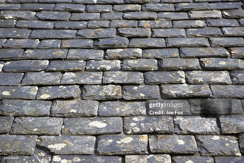 Old, weathered, heavy slate roof tiles