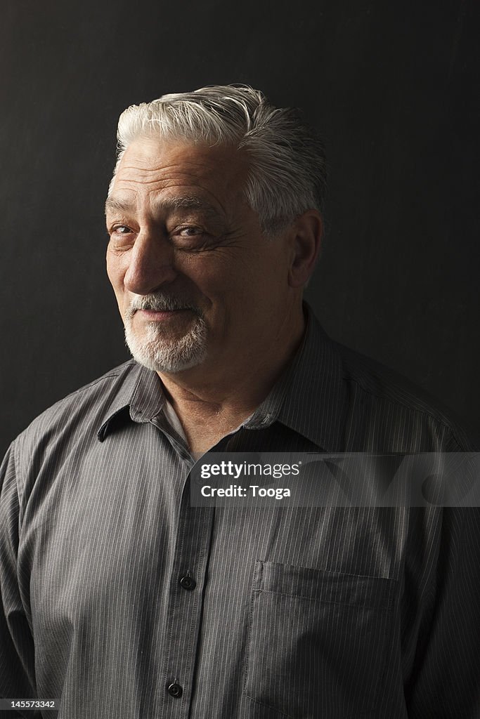 Portrait of confident and silver haired man