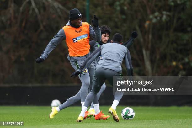 Toti Gomes is challenged by Goncalo Guedes and Nelson Semedo of Wolverhampton Wanderers during a Wolverhampton Wanderers Training Session at The Sir...