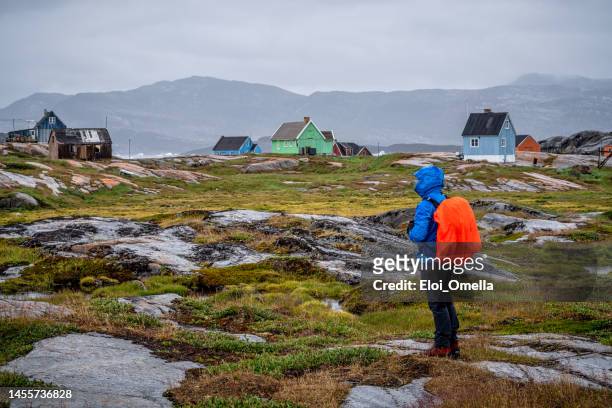 tourist visiting oqaatsut. greenland - disko bay stock pictures, royalty-free photos & images