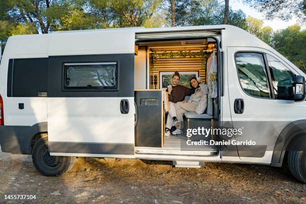 couple in love enjoying a getaway in the mountains, toasting looking at the camera, camping themes, campervan backgrounds - portrait of a camper stock pictures, royalty-free photos & images