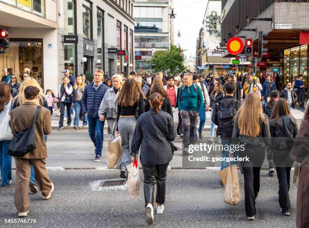 weekend pedestrians in stockholm's city centre - stockholm winter stock pictures, royalty-free photos & images