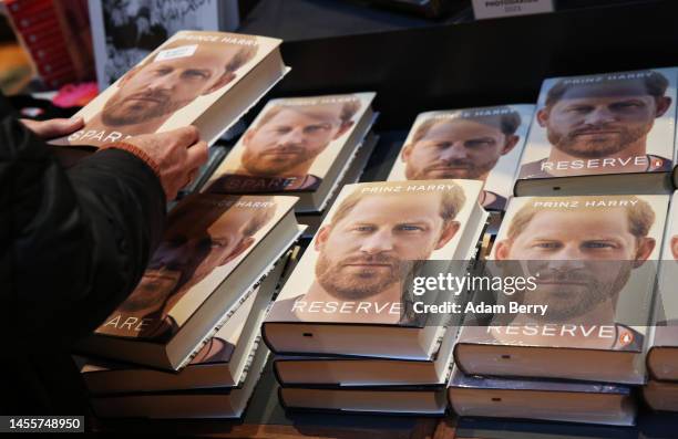 Customer looks at copies of Prince Harry’s memoir “Spare” on display at the Dussmann das KulturKaufhaus bookshop, on January 11, 2023 in Berlin,...