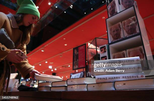 Customer looks at copies of Prince Harry’s memoir “Spare” on display at the Dussmann das KulturKaufhaus bookshop, on January 11, 2023 in Berlin,...
