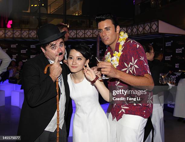 Charlie Chaplin impersonator, guest and an Elvis Presley impersonator attend the Montblanc international gala to celebrate the official opening of...