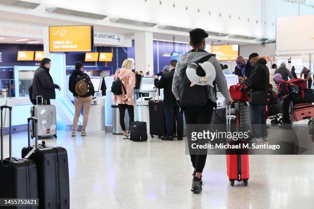 People check-in for their flight at JFK airport on January 11, 2023 in New York City. Thousands of flights throughout the country were grounded after...