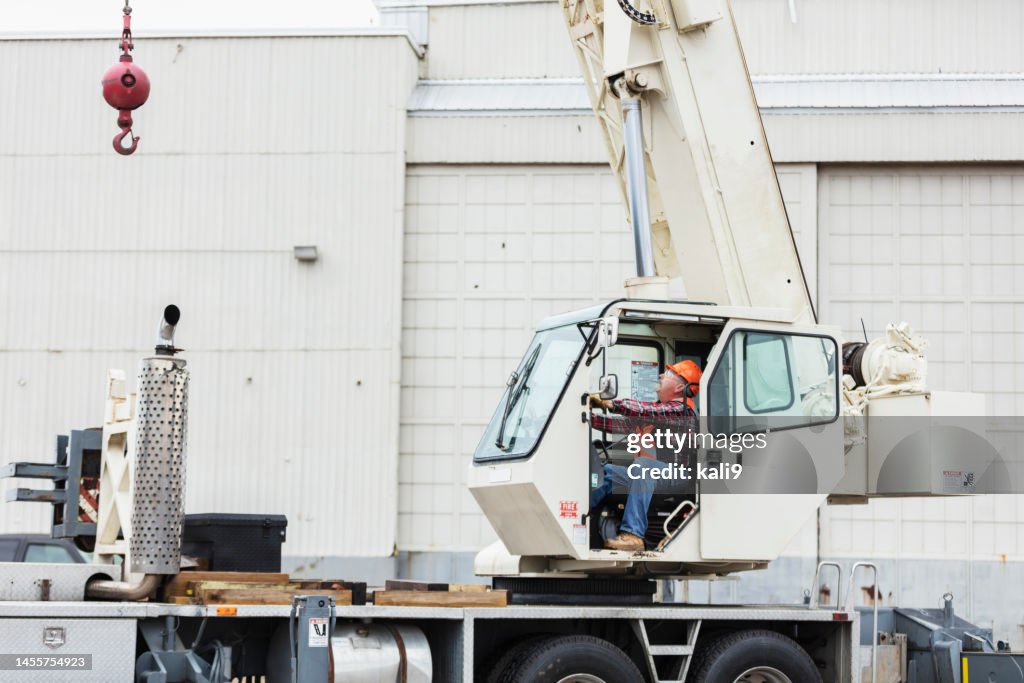 Senior man operating a crane