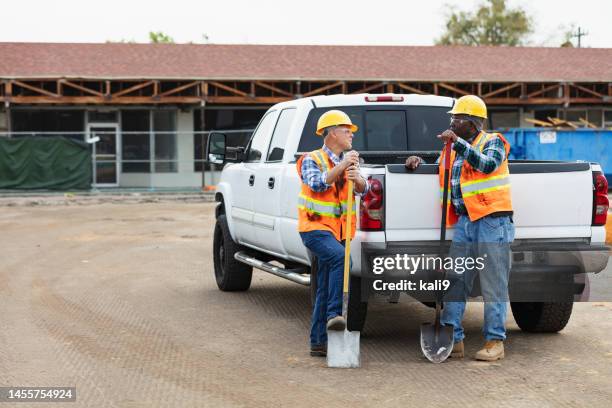 construction workers with shovels converse by pickup truck - pick up truck stock pictures, royalty-free photos & images