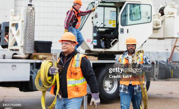 construction workers preparing to use mobile crane - mobile crane stock pictures, royalty-free photos & images