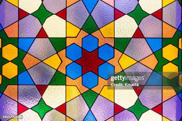 multi colored stained glass on window. - stained glass stockfoto's en -beelden