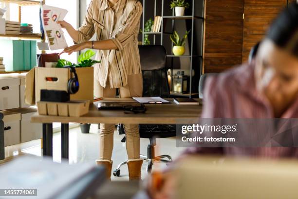 young businesswoman packing her desk after getting fired from her job - being fired stock pictures, royalty-free photos & images