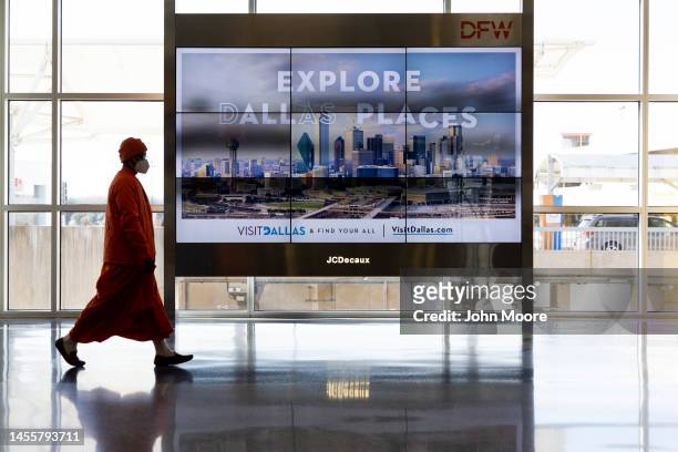Passengers pass through Dallas-Fort Worth International Airport on January 11, 2023 in Dallas, Texas. Thousands of flights throughout the country are...