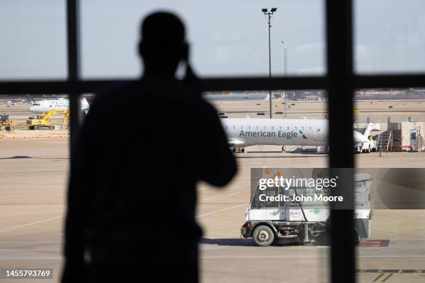 Passenger awaits his flight at Dallas-Fort Worth International Airport on January 11, 2023 in Dallas, Texas. Thousands of flights throughout the...