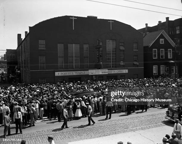 Elevated view of a crowd outside Roberts Temple Church of God in Christ as members of Emmett Till's family leave for his burial service, Chicago,...