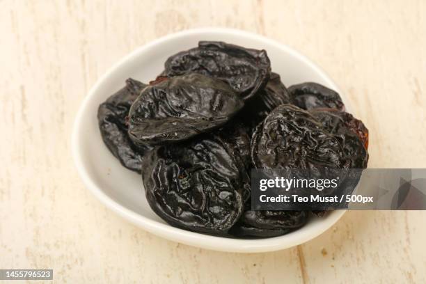 close-up of dates in bowl on table,arad,romania - dried plum stock pictures, royalty-free photos & images