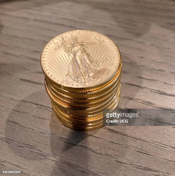 Stack of American Eagle Coins, BU, on tabletop.