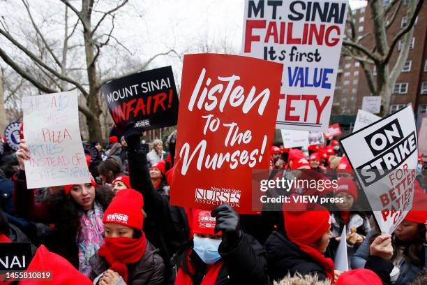 Nurses hold placards as they shout slogans at Mount Sinai Hospital during their 3rd day on strike on January 11, 2023 in New York City. About 7000...
