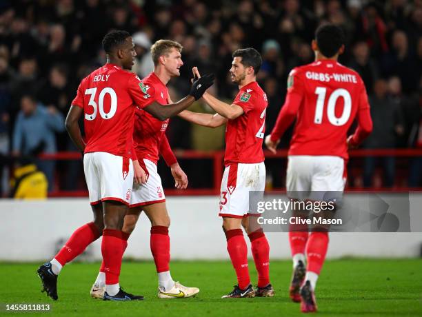 Willy Boly of Nottingham Forest celebrates with teammate Remo Freuler after scoring the team's first goal during the Carabao Cup Quarter Final match...