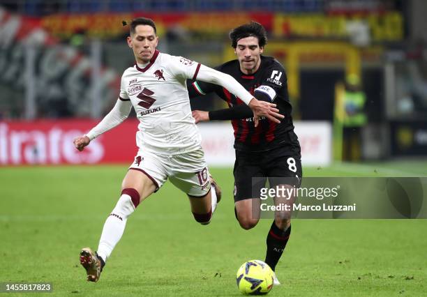 Sandro Tonali of AC Milan battles for possession with Sasa Lukic of Torino FC during the Coppa Italia match between AC Milan and Torino FC at Stadio...