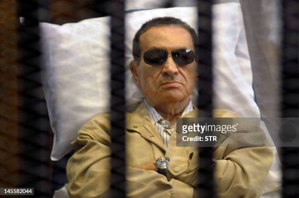 Ousted Egyptian president Hosni Mubarak sits inside a cage in a courtroom during his verdict hearing in Cairo on June 2, 2012. A judge sentenced...