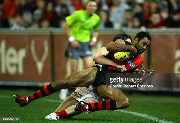 Nathan Lovett-Murray of the Bombers is tackled during the round 10 AFL match between the Essendon Bombers and the Melbourne Demons at the Melbourne...