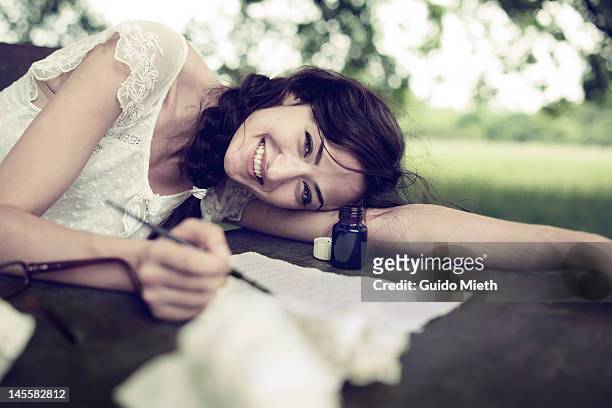 woman writing love letter with ink - love letter stock-fotos und bilder