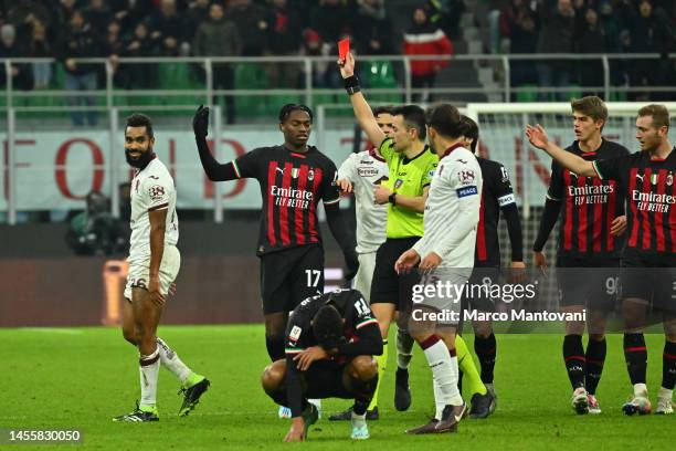 Referee Antonio Rapuano shows the red card to Koffi Djidji of Torino FC during the Coppa Italia match between AC Milan and Torino FC at Stadio...