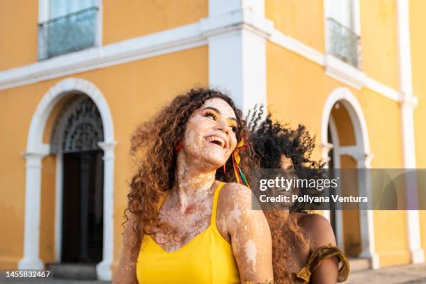 young women laughing outdoors - vitiligo stock pictures, royalty-free photos & images