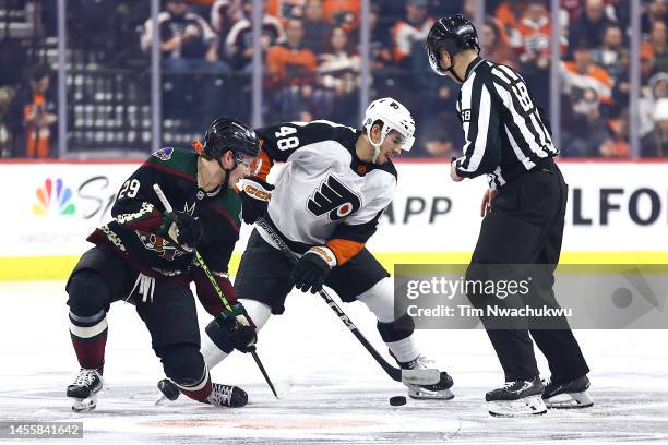 Barrett Hayton of the Arizona Coyotes and Morgan Frost of the Philadelphia Flyers challenge for the puck at Wells Fargo Center on January 05, 2023 in...