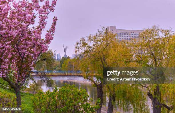 scenic view on motherland mother monument from flourishing rusanivka park. springtime - kyiv spring stock pictures, royalty-free photos & images