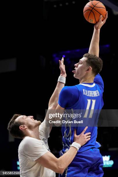 Ryan Kalkbrenner of the Creighton Bluejays shoots over Jack Nunge of the Xavier Musketeers in the first half at the Cintas Center on January 11, 2023...