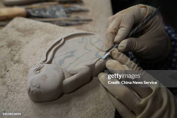 Craftsman carves a rabbit-shaped inkstone as the Chinese Lunar New Year of the Rabbit approaches on January 11, 2023 in Yuncheng, Shanxi Province of...