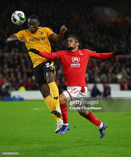 Toti Gomes of Wolverhampton Wanderers heads the ball whilst under pressure from Gustavo Scarpa of Nottingham Forest during the Carabao Cup Quarter...