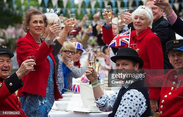 People toast as they take part in a street party organised by residents of Battersea in south London on June 2 as Britain celebrates Queen Elizabeth...
