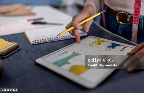 close-up on a fashion designer sketching at her atelier - fashion studio stock pictures, royalty-free photos & images