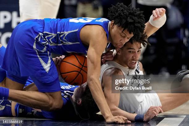 Trey Alexander of the Creighton Bluejays and Colby Jones of the Xavier Musketeers battle for a loose ball in the second half at the Cintas Center on...