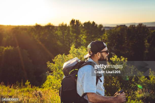 man on a hike with sunflare outdoors in scenic nature - bozeman stock pictures, royalty-free photos & images