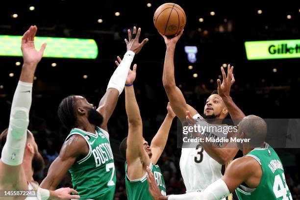 McCollum of the New Orleans Pelicans takes a shot against Jaylen Brown, Al Horford and Grant Williams of the Boston Celtics during the second half at...